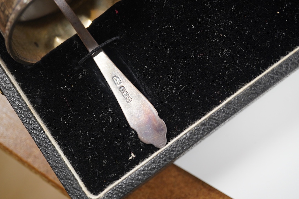 A cased set of six Victorian silver apostle teaspoons, tongs and caddy spoon, 1882, 3.7oz, and a cased George VI silver christening set comprising egg cup, napkin and spoon, 2.6oz. Condition - good.